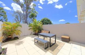 
a row of benches sitting next to each other on a patio at Alexandra Apartments in Bundaberg
