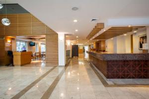 a lobby of a hotel with a reception desk at Hotel Plaza Calzada in Monterrey