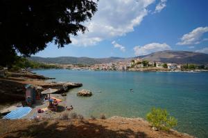 a group of people on a beach in the water at Seafarer's Suite in Galaxidi