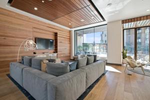 a living room with a large couch and a tv at Global Luxury Suites at Downtown Mountain View in Mountain View
