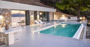a villa with a swimming pool and a patio at Thalasses Villas Skiathos in Skiathos
