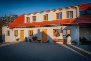 a large white house with an orange roof at Včelařství pod svatým Floriánem in Znojmo