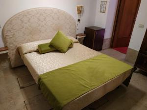 a bedroom with a bed with a green pillow on it at Alloggi Acquavita - checkin at "Alloggi SS Giovanni e Paolo" in Venice