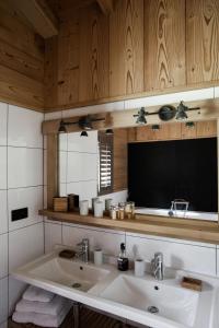a bathroom with a large white sink and wooden cabinets at Chalet 4M Les Carroz et son Spa in Les Carroz d'Araches +45 photos