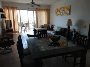a living room with a table and a couch at Apartamento Pelicanos, Nuevo Vallarta in Nuevo Vallarta