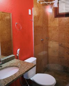 a bathroom with a shower and a toilet and a sink at Pouso do Kite Pousada Flecheiras in Flecheiras
