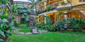 ogród przed budynkiem pełnym roślin w obiekcie Hotel Las Camelias Inn by AHS w mieście Antigua Guatemala