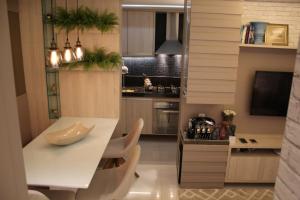 a kitchen with a white table and chairs at Apartamento Emaús in Parnamirim