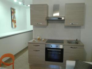 a kitchen with a stove and a sink in it at CASETTA RELAX A SUTRI in Sutri