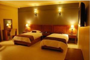 Ένα ή περισσότερα κρεβάτια σε δωμάτιο στο La Rosa Hotel By Brother International