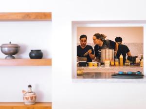 a group of people preparing food in a kitchen at Noku Beach House by Elite Havens in Seminyak