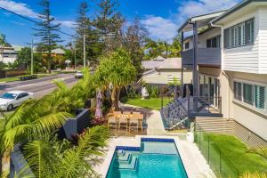 an aerial view of a house with a swimming pool at Aloha Byron Bay in Byron Bay