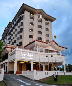 a hotel with a sign on the front of it at Mulia Hotel in Bandar Seri Begawan