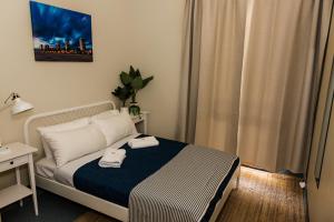 a bedroom with a bed with two towels on it at Coolangatta Sands Hotel in Gold Coast