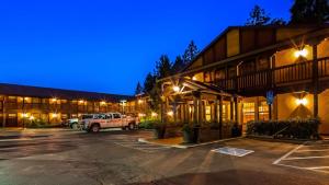 a building with a truck parked in a parking lot at Best Western Stagecoach Inn in Pollock Pines
