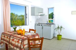 a kitchen with a table with fruit on it at Garifalo Apartments in Kalyves