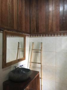 a bathroom with a sink and a mirror at Linda Beach Hotel in Nusa Lembongan