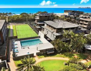 an aerial view of a house with a swimming pool at Majorca Isle Beachside Resort in Maroochydore