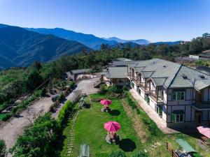 an aerial view of a house with two pink umbrellas at StarVilla in Renai