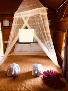 a bedroom with a bed with a net at Khao Sok Blue Mountain in Khao Sok