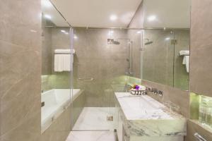 a bathroom with a shower and a sink and a tub at Parc Borough City Resort in Chiang Mai