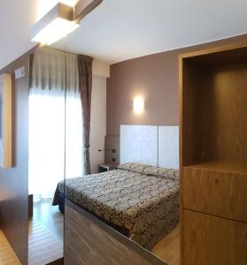 Кровать или кровати в номере Albergo Ristorante Il Delfino