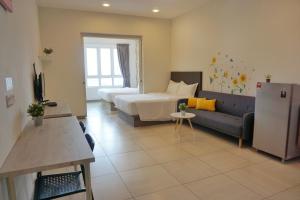 a living room with a bed and a couch at PM Octagon Ipoh Suites & Apartment 2 in Ipoh