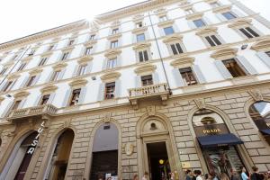 a large white building with people walking in front of it at B&B La Terrazza Sul Duomo in Florence
