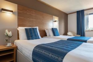 a hotel room with two beds and a window at Passage House Hotel in Newton Abbot