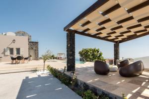a view of a patio with chairs under a pavilion at Amaranthine Villa in Imerovigli