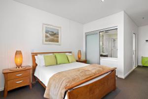 A bed or beds in a room at The Frontage Resort-Style Apartment