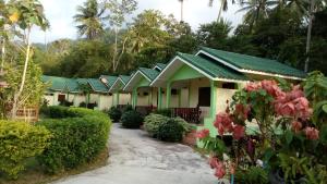 a row of houses with green roofs at Tara Resort in Nathon