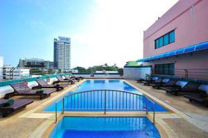 a swimming pool on the roof of a building at Thipurai City Hotel in Hua Hin