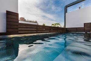 a swimming pool in front of a building at Terreno Studios in Palma de Mallorca