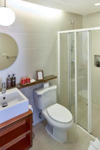 a bathroom with a toilet and a shower and a sink at Bandara On Sea, Rayong in Klaeng