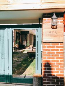 an entrance to a brick building with a sign on it at ANC HOUSE in Gangneung