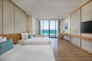 TV a/nebo společenská místnost v ubytování TMS Hotel Da Nang Beach