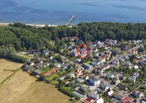 an aerial view of a small town with a red circle at Haus Clara Wohnung 1 in Ostseebad Koserow