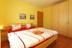 a bedroom with a large bed with a stuffed animal on it at Haus Clara Wohnung 1 in Ostseebad Koserow