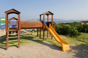 a park with a playground with a slide and a slideintend at Camping Acapulco in Palau