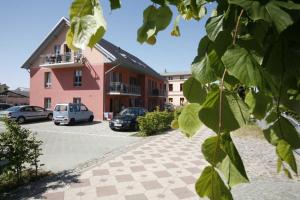 a building with cars parked in a parking lot at Haus Clara Wohnung 05 in Ostseebad Koserow