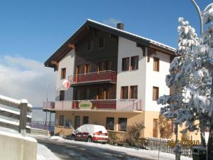 a large building with a car parked in front of it at Hotel Restaurant Emshorn in Oberems