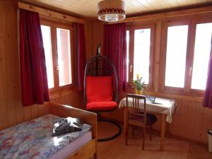 a bedroom with a bed and a chair and a desk at Hotel Restaurant Emshorn in Oberems