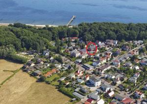 an aerial view of a house with a red circle at Haus Grete Wohnung 10 in Ostseebad Koserow