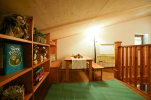 Zimmer mit einem Tisch, einem Tisch und einem grünen Teppich in der Unterkunft Chalet Galli in Abbadia San Salvatore