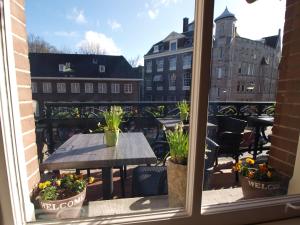 a patio table with a window overlooking a city at Hotel Clemens in Amsterdam