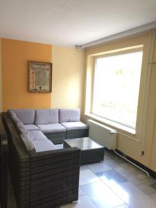 a living room with a couch and a window at Hotel Heidenschanze in Dresden