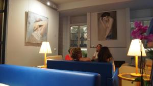 a group of people sitting in a waiting room at Hotel Lucerna in Castiglione della Pescaia