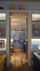 a hallway with a dining room and a living room at Hotel Lucerna in Castiglione della Pescaia