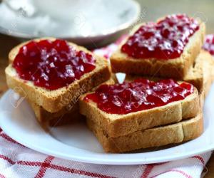 three pieces of bread with jam on a plate at Ahlan Green Apple Dormitory in Mumbai